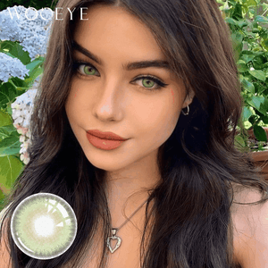 The girl's face is looking straight ahead, the upper left is the Wooeye logo, and the lower left is a close-up of the la girl green contact lens