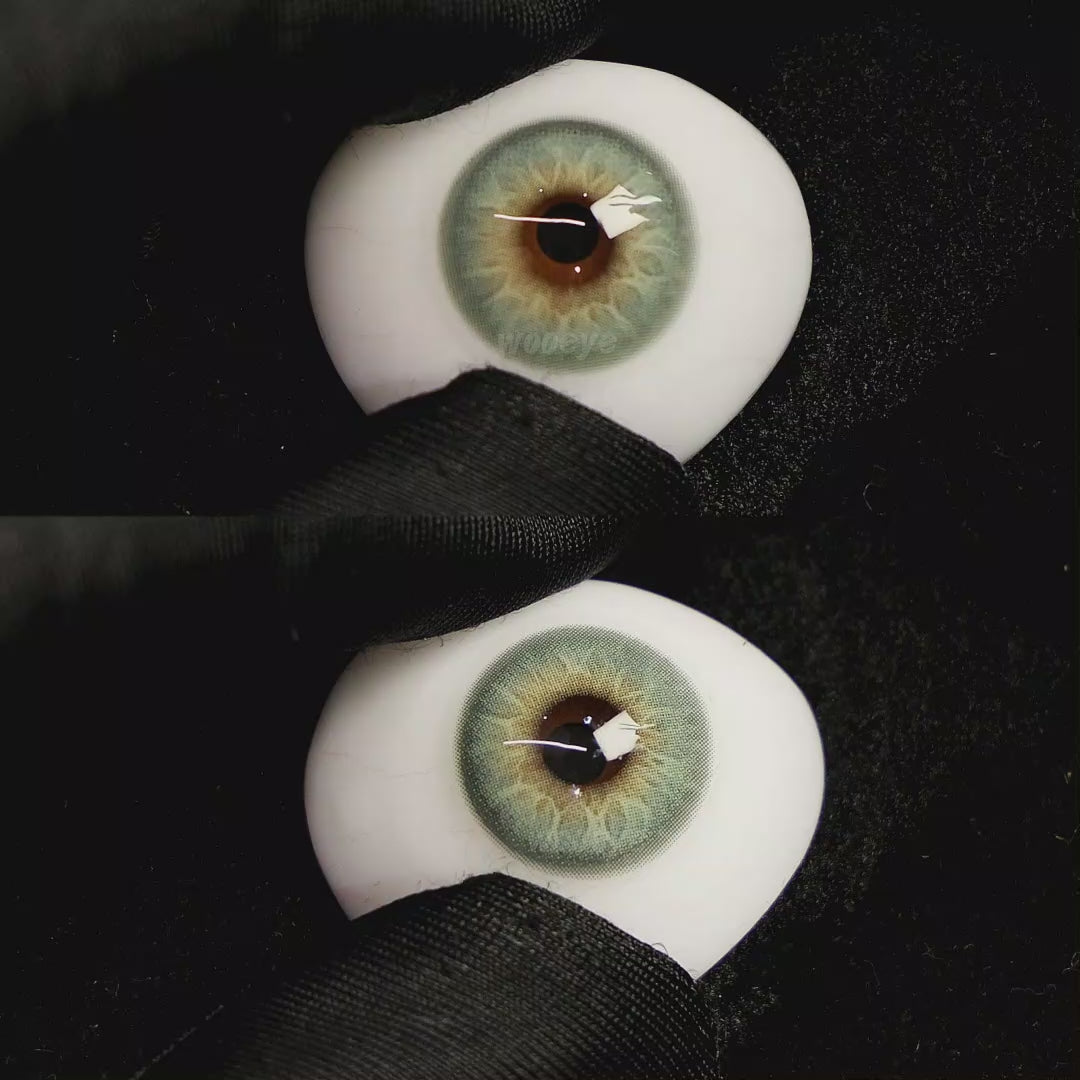 A simulated brown prosthetic eye showing the visual transformation effect of wearing Moonlit Blue colored contact lenses against a black background.