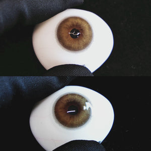 Mystery Brown contact lenses on a brown simulated eyeball with a black background