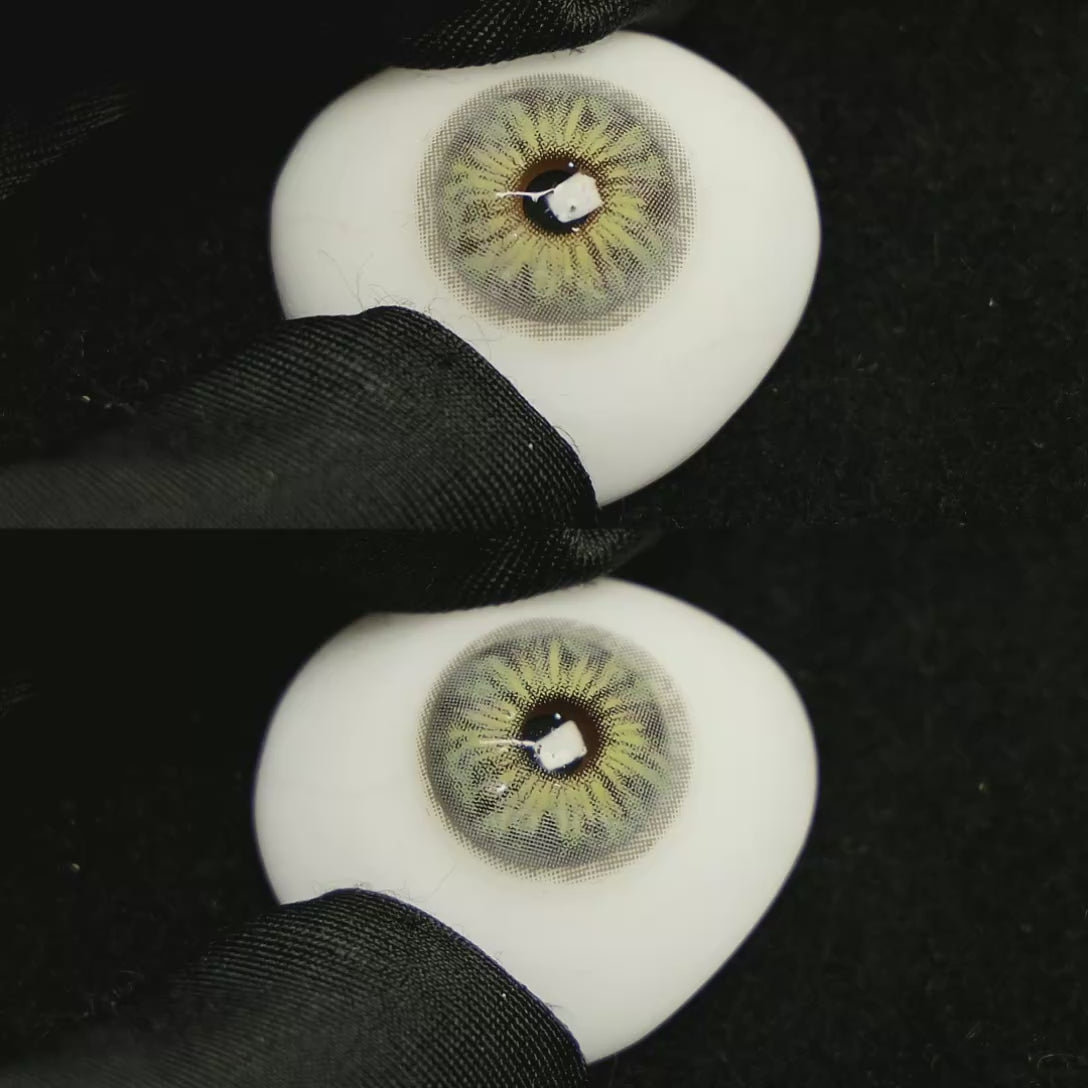 A simulated brown prosthetic eye showing the visual transformation effect of wearing Chamer Grey I colored contact lenses against a black background.