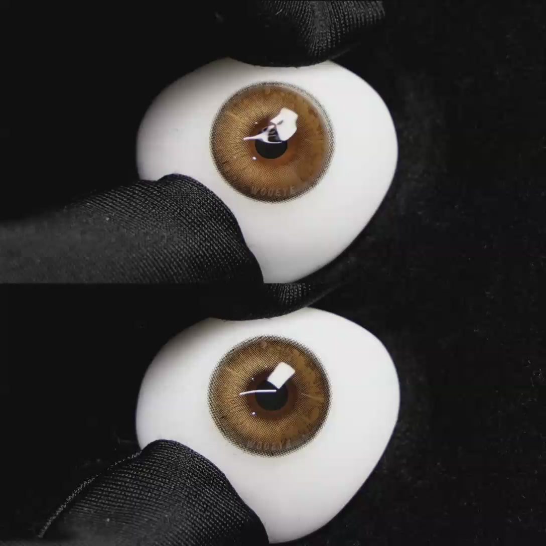 A simulated brown prosthetic eye showing the visual transformation effect of wearing Wooeye Soul Brown colored contact lenses against a black background.