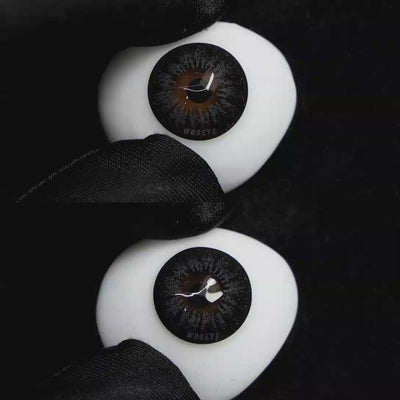 A simulated brown prosthetic eye showing the visual transformation effect of wearing Wooeye Pearl Gray I colored contact lenses against a black background.