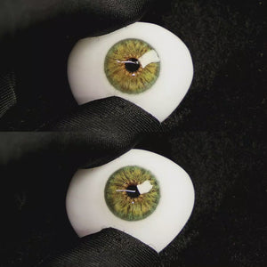 A simulated brown prosthetic eye showing the visual transformation effect of wearing Petal Green colored contact lenses against a black background.