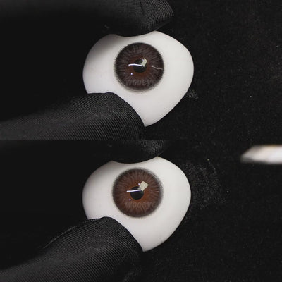 A simulated brown prosthetic eye showing the visual transformation effect of wearing chocolate oat gray ii colored contact lenses against a black background.