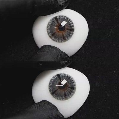 A simulated brown prosthetic eye showing the visual transformation effect of wearing Wooeye Plato Gray colored contact lenses against a black background.