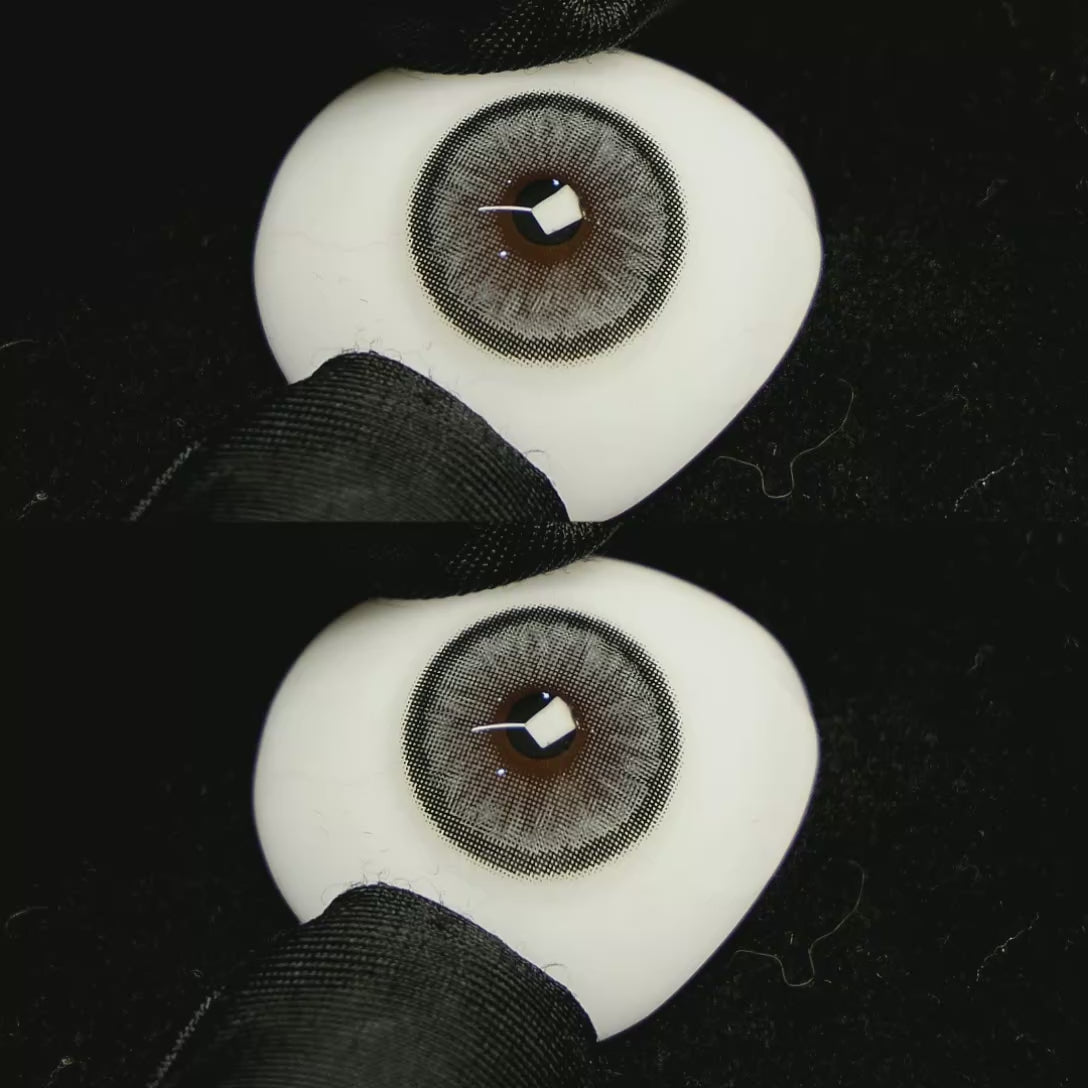 A simulated brown prosthetic eye showing the visual transformation effect of wearing Sugar Grey colored contact lenses against a black background.