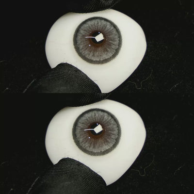 A simulated brown prosthetic eye showing the visual transformation effect of wearing Sugar Grey colored contact lenses against a black background.