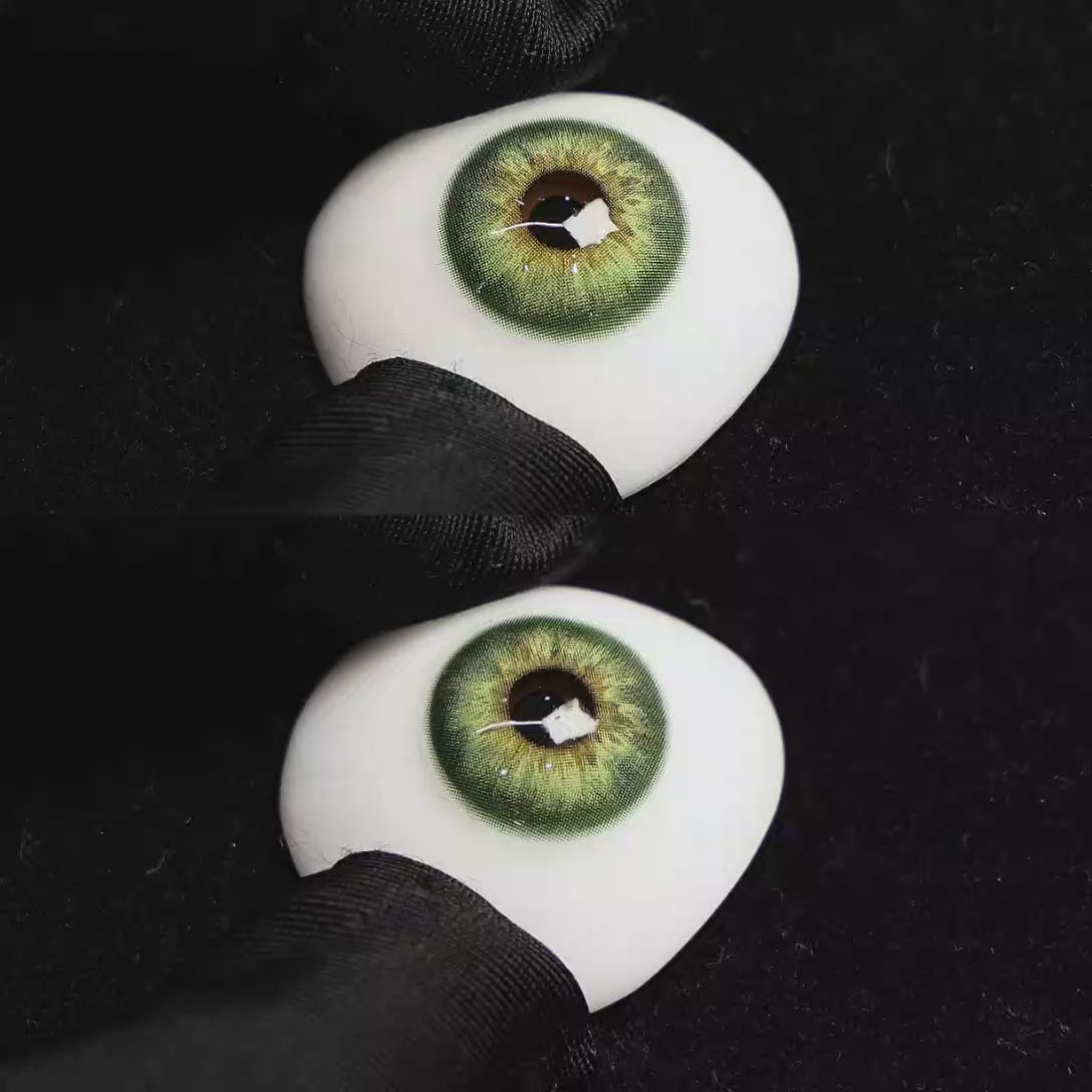 A simulated brown prosthetic eye showing the visual transformation effect of wearing Origin Glow Hazel Brown colored contact lenses against a black background.