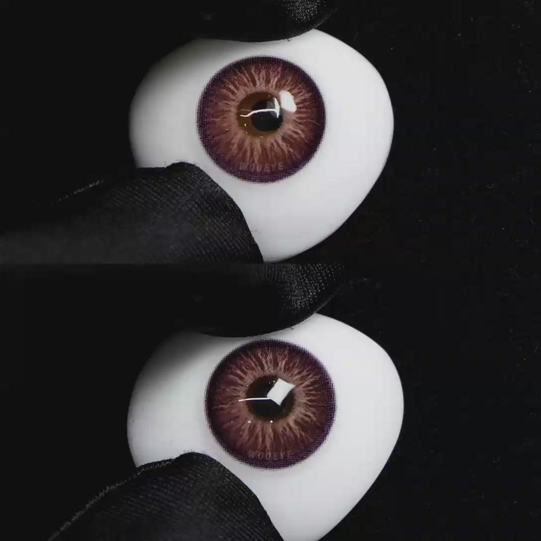 A simulated brown prosthetic eye showing the visual transformation effect of wearing Wooeye Elf Purple colored contact lenses against a black background.