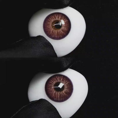 A simulated brown prosthetic eye showing the visual transformation effect of wearing Wooeye Elf Purple colored contact lenses against a black background.