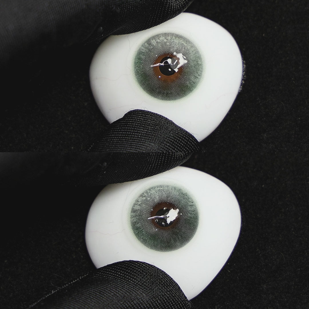 Clouds Green contact lenses on a brown simulated eyeball with a black background