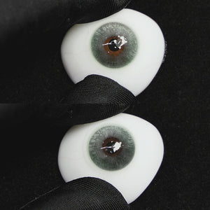 Clouds Green contact lenses on a brown simulated eyeball with a black background