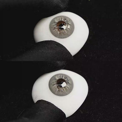 A simulated brown prosthetic eye showing the visual transformation effect of wearing Cape Cod Grey colored contact lenses against a black background.