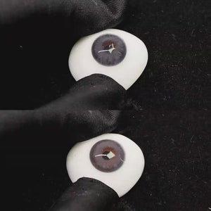 A simulated brown prosthetic eye showing the visual transformation effect of wearing banshe light blue colored contact lenses against a black background.
