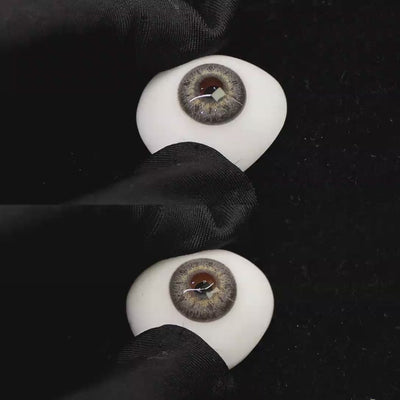 A simulated brown prosthetic eye showing the visual transformation effect of wearing banshe gray colored contact lenses against a black background.