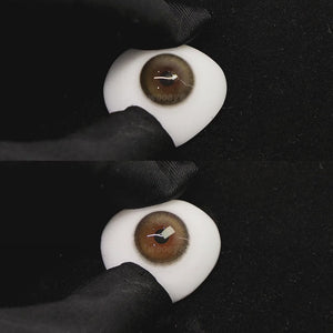 A simulated brown prosthetic eye showing the visual transformation effect of wearing caramel brown colored contact lenses against a black background.