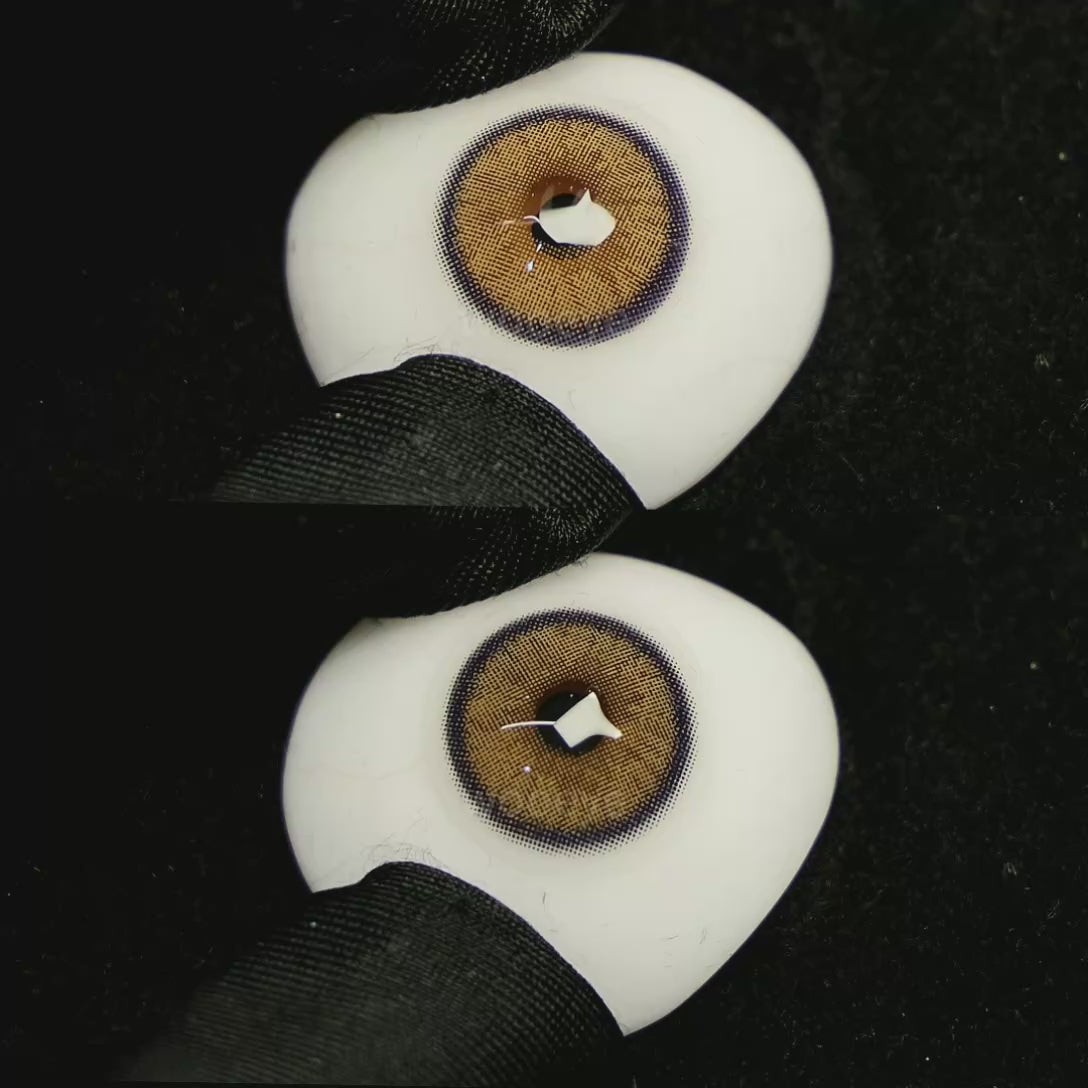 A simulated brown prosthetic eye showing the visual transformation effect of wearing Grape Brown colored contact lenses against a black background.