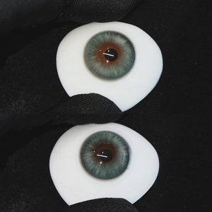Mystery Green contact lenses on a brown simulated eyeball with a black background
