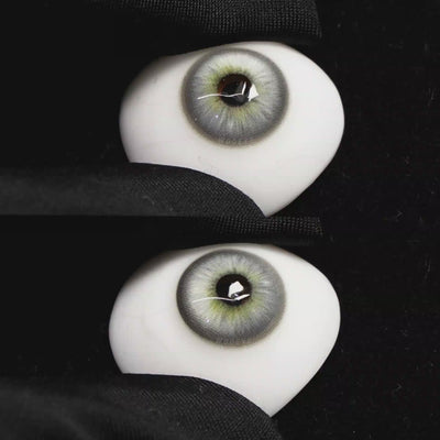 A simulated brown prosthetic eye showing the visual transformation effect of wearing Wooeye Casa Gray colored contact lenses against a black background.
