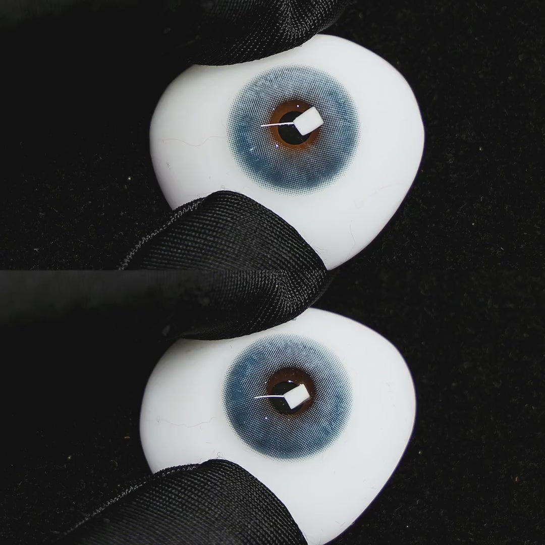 clouds blue contact lenses on a brown simulated eyeball with a black background