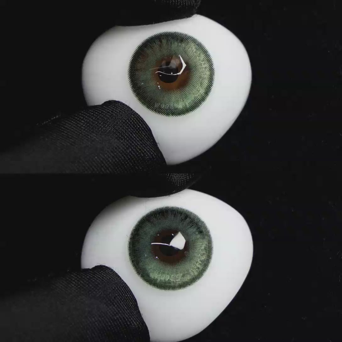A simulated brown prosthetic eye showing the visual transformation effect of wearing Wooeye Bubbles Green colored contact lenses against a black background.