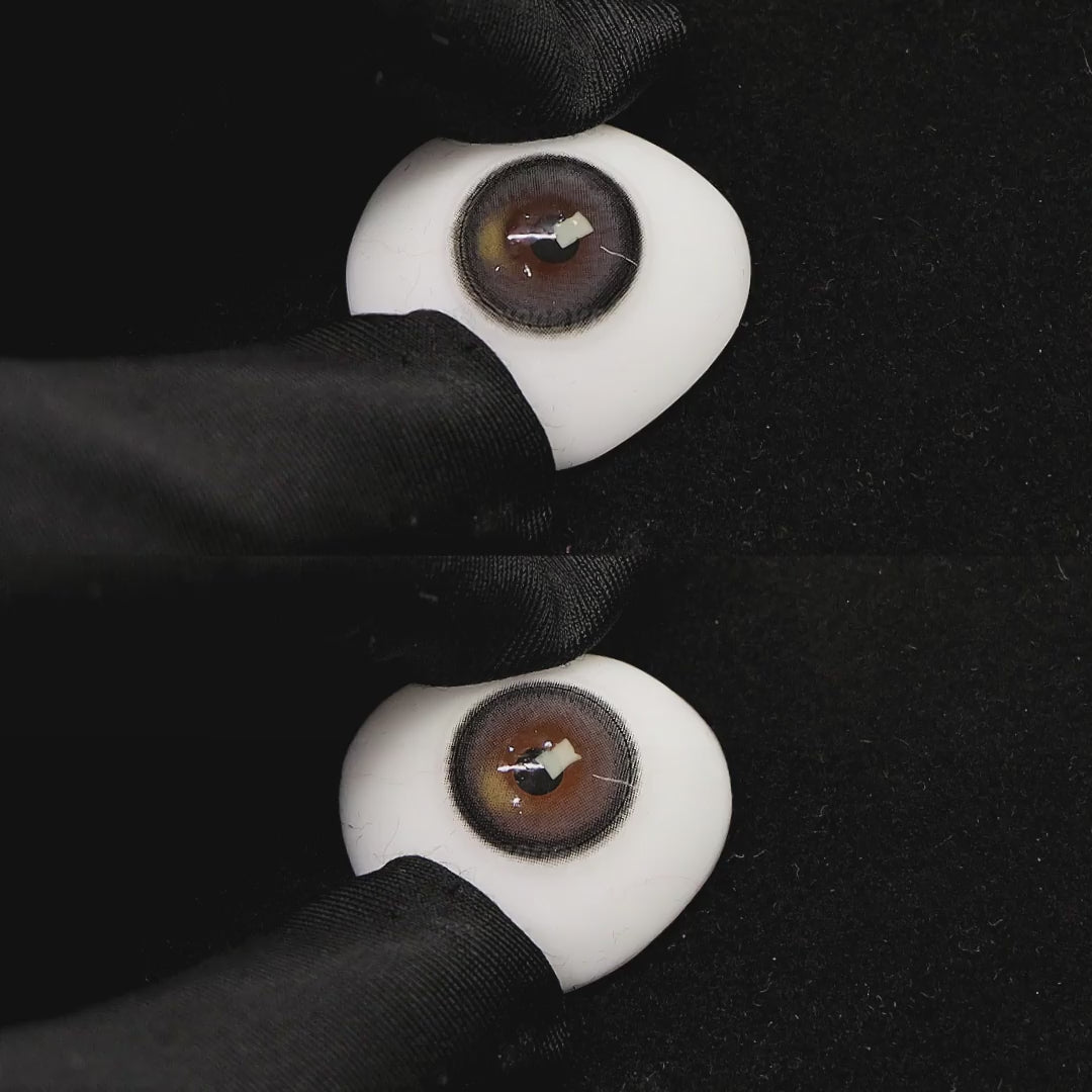 A simulated brown prosthetic eye showing the visual transformation effect of wearing misty gray colored contact lenses against a black background.