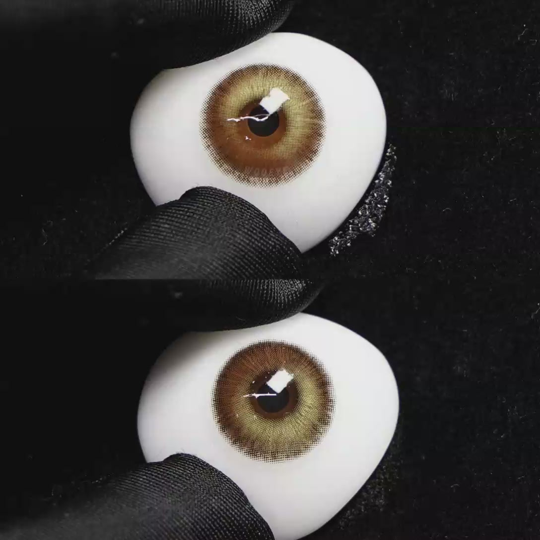 A simulated brown prosthetic eye showing the visual transformation effect of wearing Wooeye Romantic Brown colored contact lenses against a black background.
