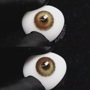 A simulated brown prosthetic eye showing the visual transformation effect of wearing Wooeye Romantic Brown colored contact lenses against a black background.