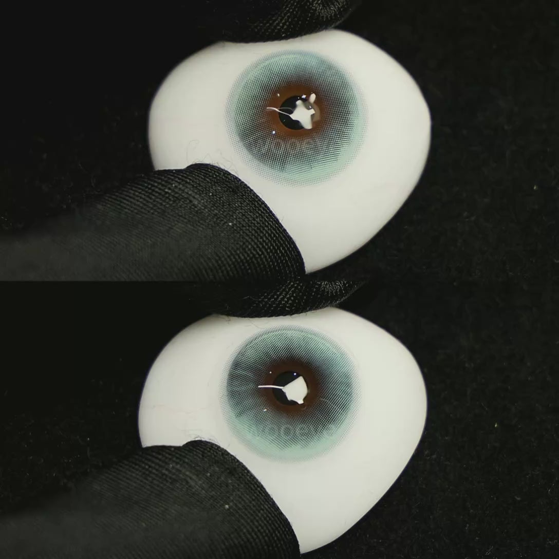 A simulated brown prosthetic eye showing the visual transformation effect of wearing Milk Blue colored contact lenses against a black background.
