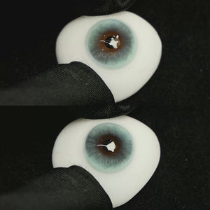 A simulated brown prosthetic eye showing the visual transformation effect of wearing Milk Blue colored contact lenses against a black background.