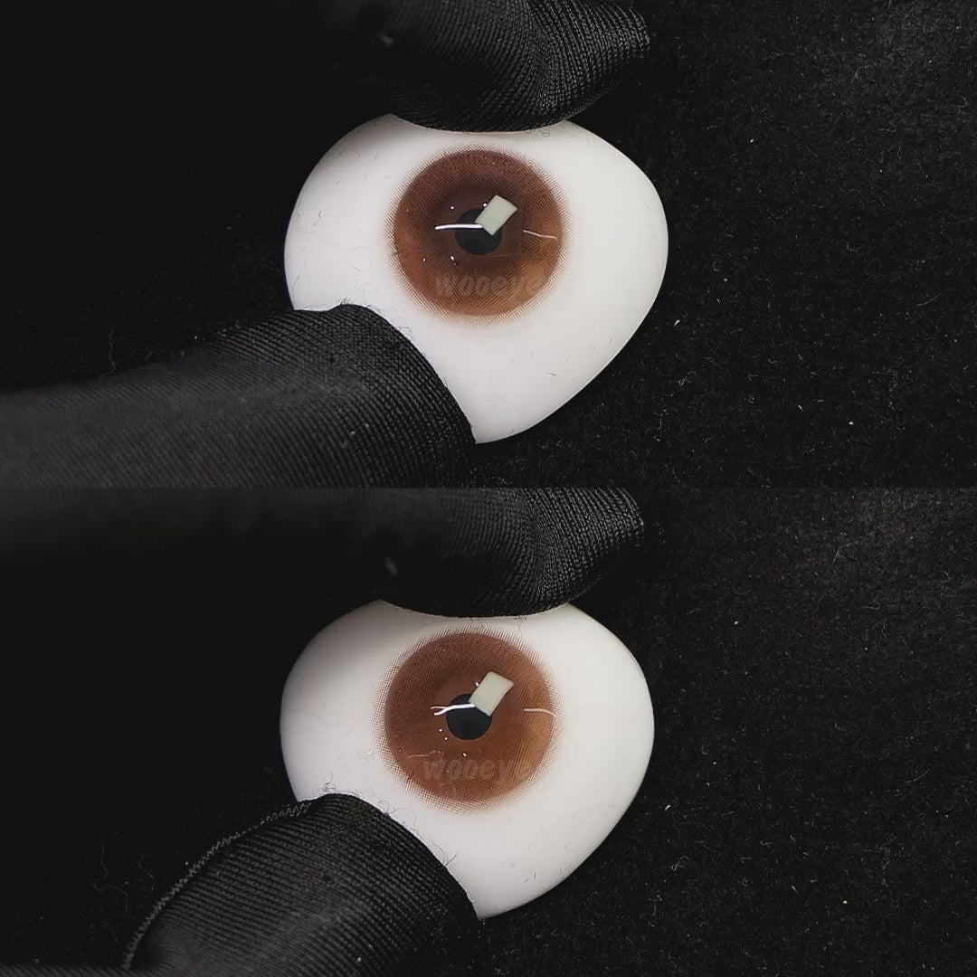 A simulated brown prosthetic eye showing the visual transformation effect of wearing coffee brown i colored contact lenses against a black background.