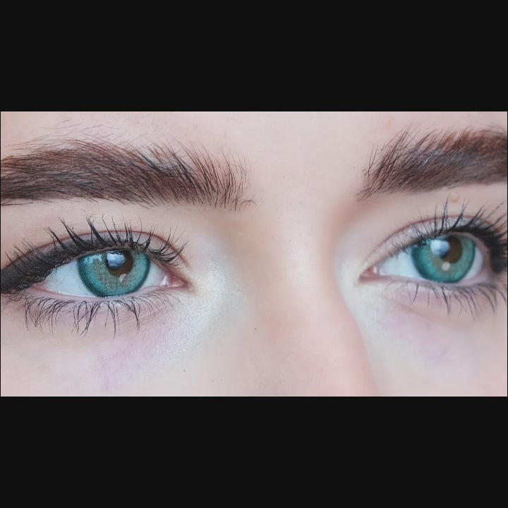 Woman winks while wearing Star Green contact lenses