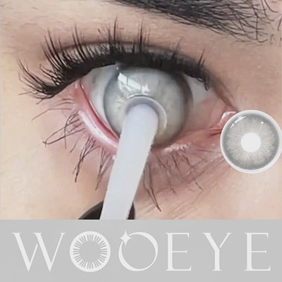 Woman blinks after wearing Lrish Gray contact lens