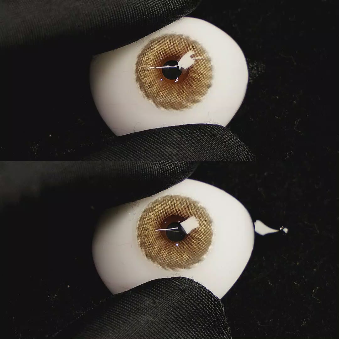 A simulated brown prosthetic eye showing the visual transformation effect of wearing Velvet Brown colored contact lenses against a black background.