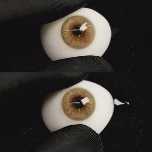 A simulated brown prosthetic eye showing the visual transformation effect of wearing Velvet Brown colored contact lenses against a black background.