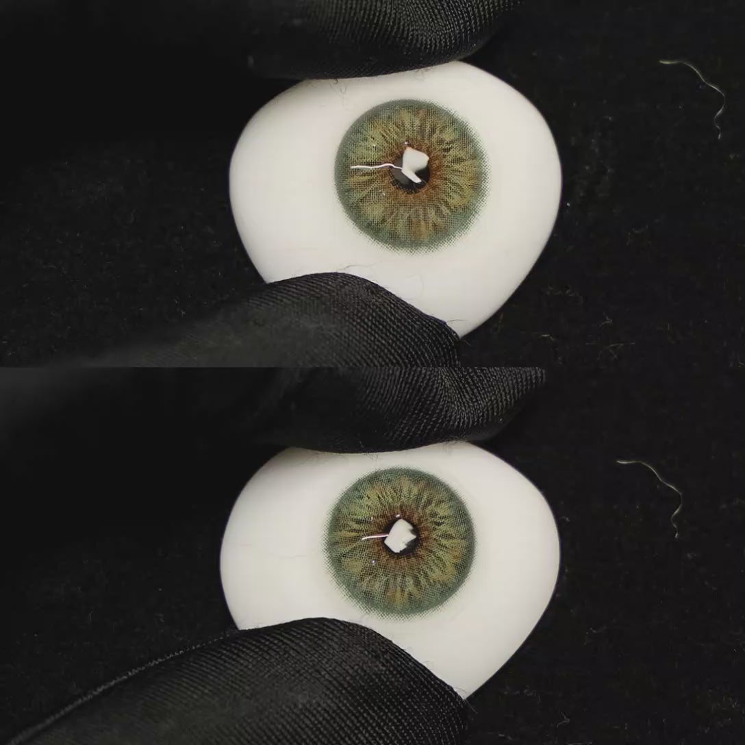 A simulated brown prosthetic eye showing the visual transformation effect of wearing Breeze Hazel Green colored contact lenses against a black background.