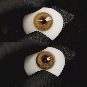 A simulated brown prosthetic eye showing the visual transformation effect of wearing Coral Brown colored contact lenses against a black background.