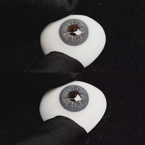 A simulated brown prosthetic eye showing the visual transformation effect of wearing Cape Cod Blue colored contact lenses against a black background.
