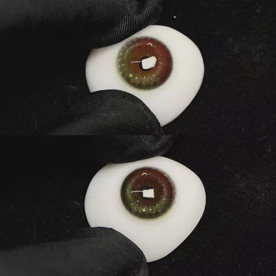 A simulated brown prosthetic eye showing the visual transformation effect of wearing Yel Dream Elflow pink colored contact lenses against a black background.