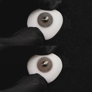 A simulated brown prosthetic eye showing the visual transformation effect of wearing mousse gray colored contact lenses against a black background.
