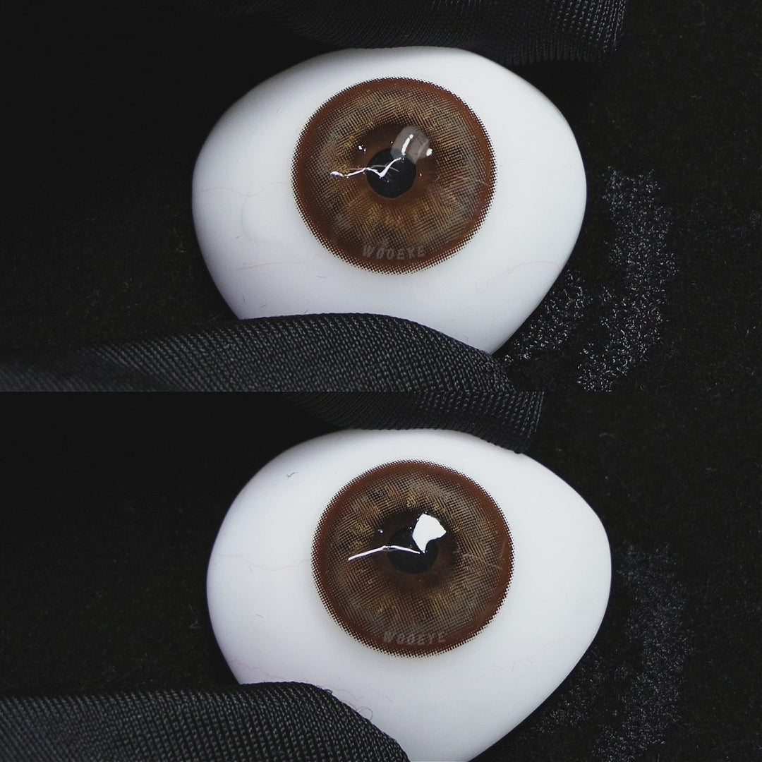 A simulated brown prosthetic eye showing the visual transformation effect of wearing Wooeye Mystery Tea Brown colored contact lenses against a black background.