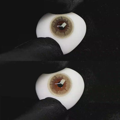 A simulated brown prosthetic eye showing the visual transformation effect of wearing Wooeye Creamy Salty White Gray colored contact lenses against a black background.