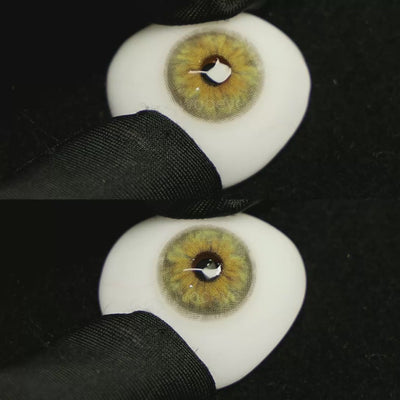 A simulated brown prosthetic eye showing the visual transformation effect of wearing Chamer Green I colored contact lenses against a black background.