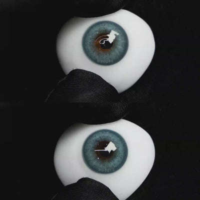 A simulated brown prosthetic eye showing the visual transformation effect of wearing Wooeye Charm Green colored contact lenses against a black background.