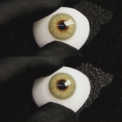 A simulated brown prosthetic eye showing the visual transformation effect of wearing Moonlit Brown colored contact lenses against a black background.