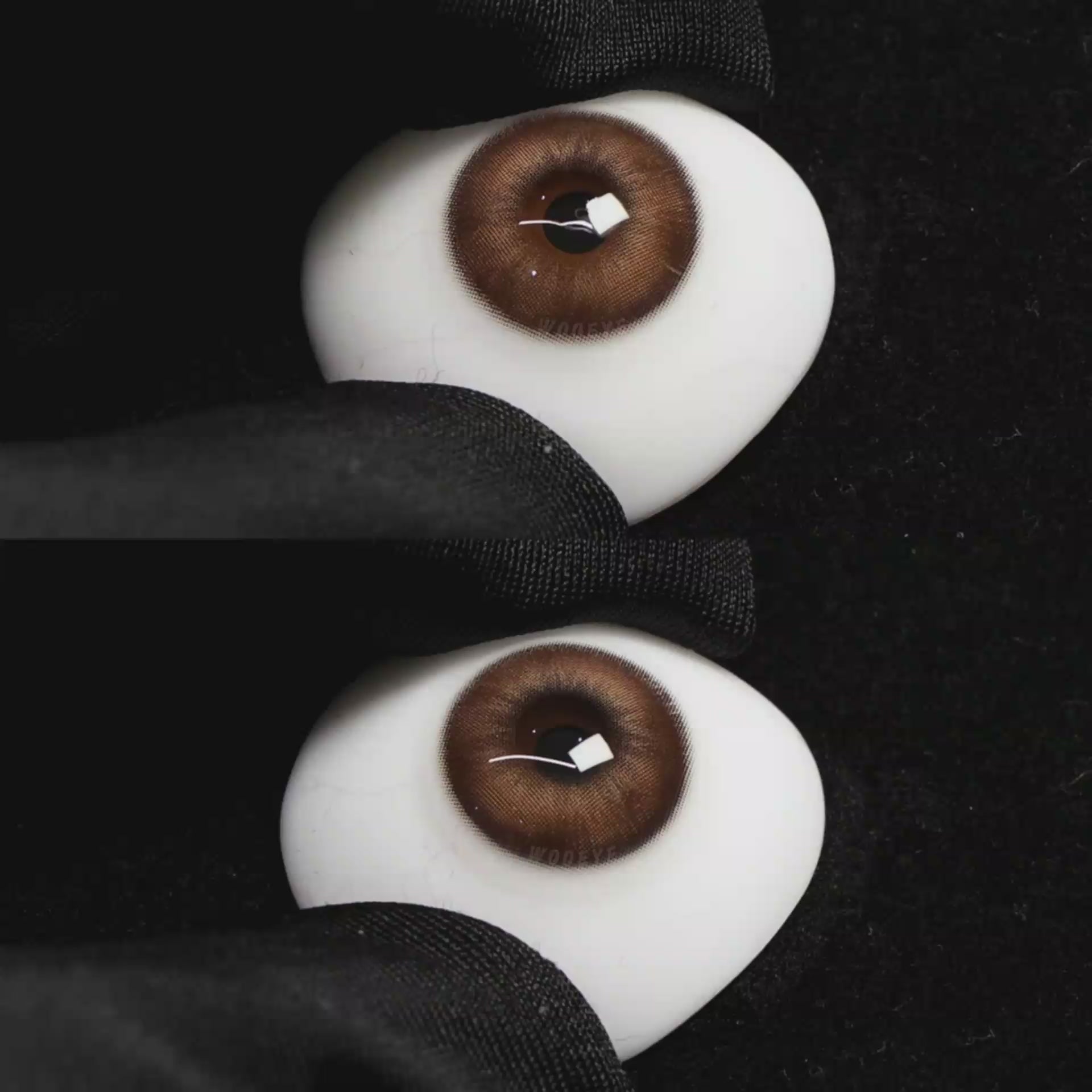 A simulated brown prosthetic eye showing the visual transformation effect of wearing Wooeye Nut Brown colored contact lenses against a black background.