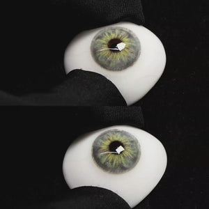 A simulated brown prosthetic eye showing the visual transformation effect of wearing Wooeye Cleo Gray colored contact lenses against a black background.
