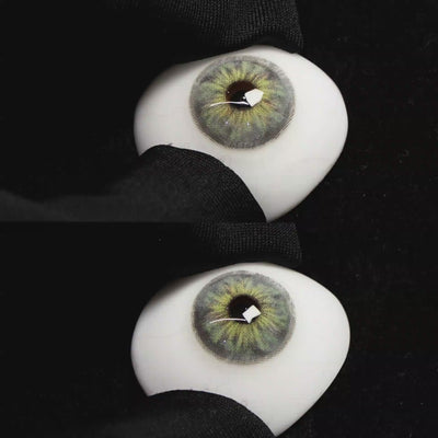 A simulated brown prosthetic eye showing the visual transformation effect of wearing Wooeye Cleo Gray colored contact lenses against a black background.