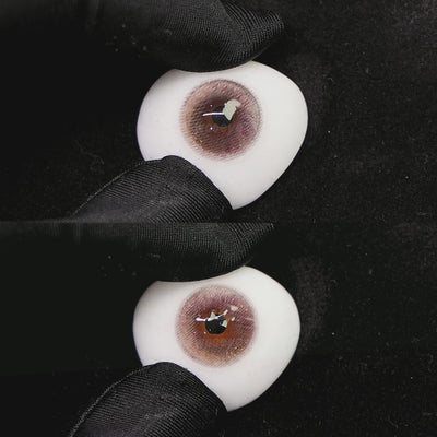 A simulated brown prosthetic eye showing the visual transformation effect of wearing princess pink colored contact lenses against a black background.