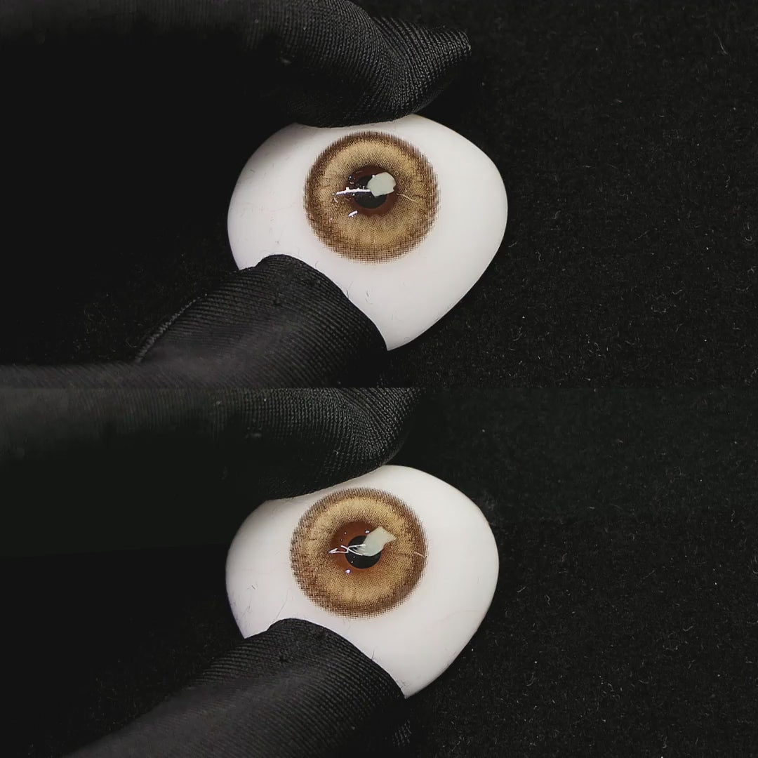 A simulated brown prosthetic eye showing the visual transformation effect of wearing princess brown colored contact lenses against a black background.
